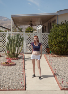 Redhead Dee Dee Lynn wears tight white shorts outside