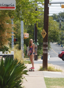 Skateboarding Ember Volland in tight cut tiny jeans shorts is flashing sexy tits in the street and undresses on the bridge