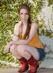 Tall baby Olivia Pelton is outside on the grass in tight jeans shorts